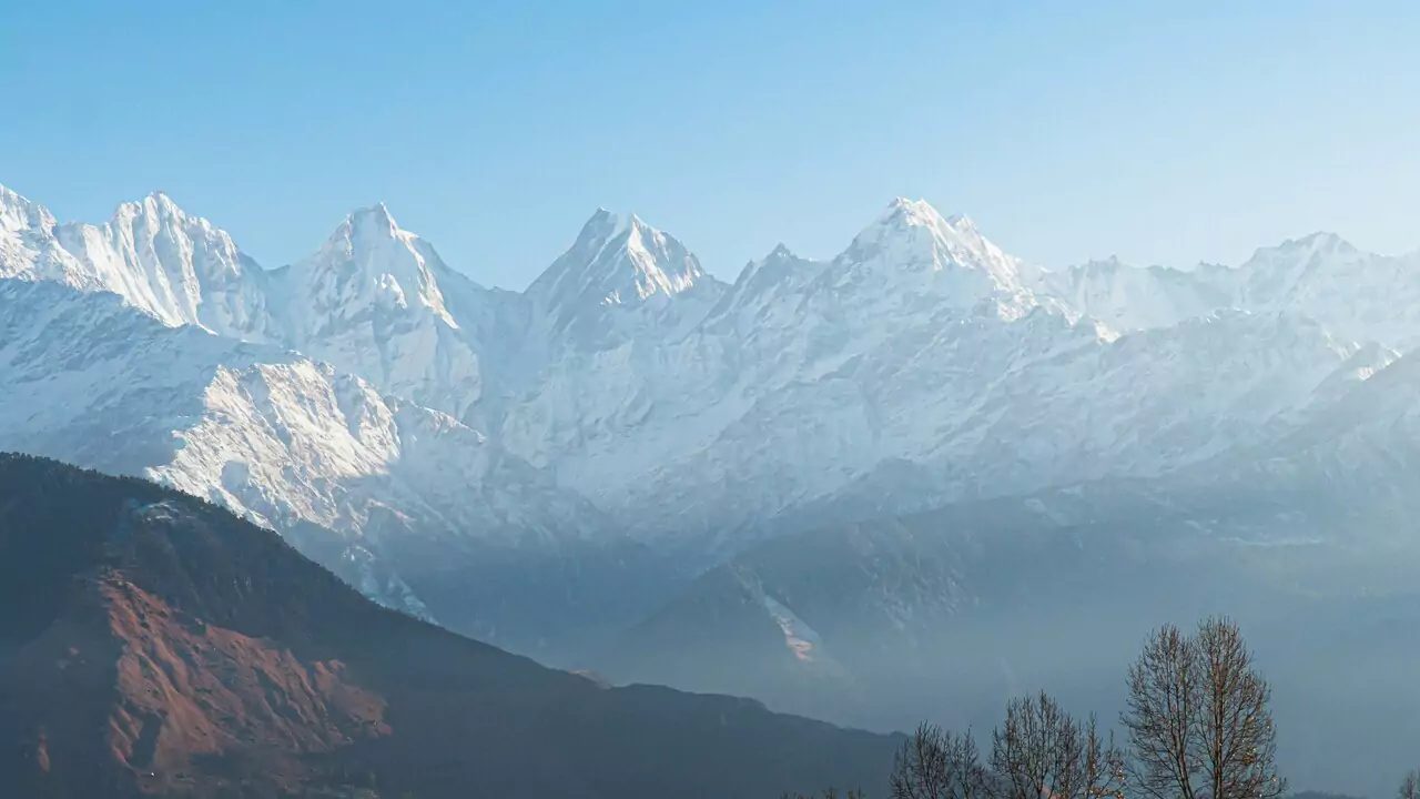 snow covered mountains in the distance in munsiyari