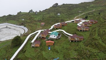 multiple houses connected together on a hill in auli