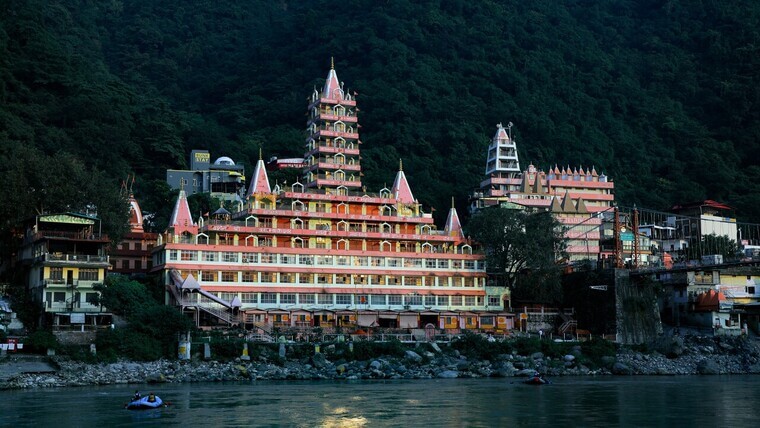 large temple located near river bank in rishikesh