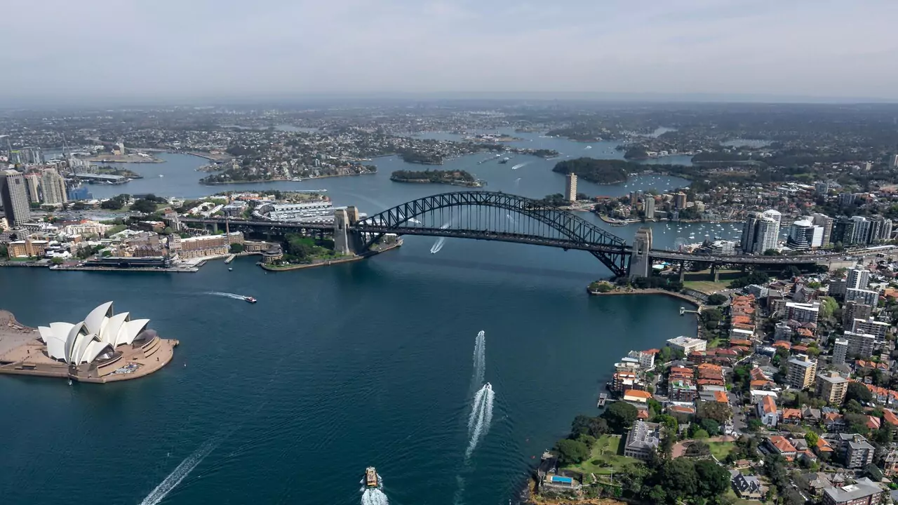 Sydney Harbour Bridge and Opera House against a clear blue sky, showcasing iconic Australian architecture.