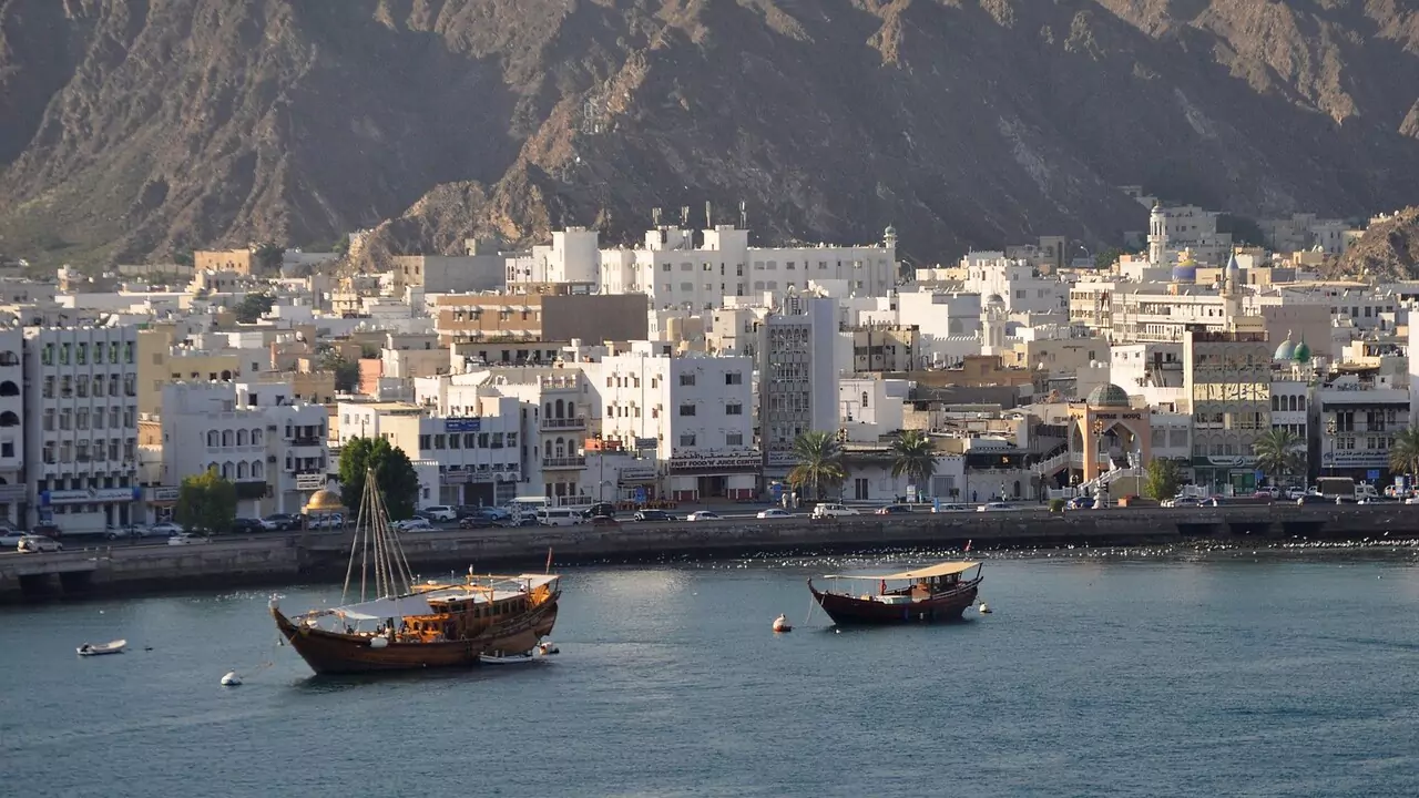 A coastal view of Oman city along the Gulf of Oman, showcasing its skyline and the blue waters