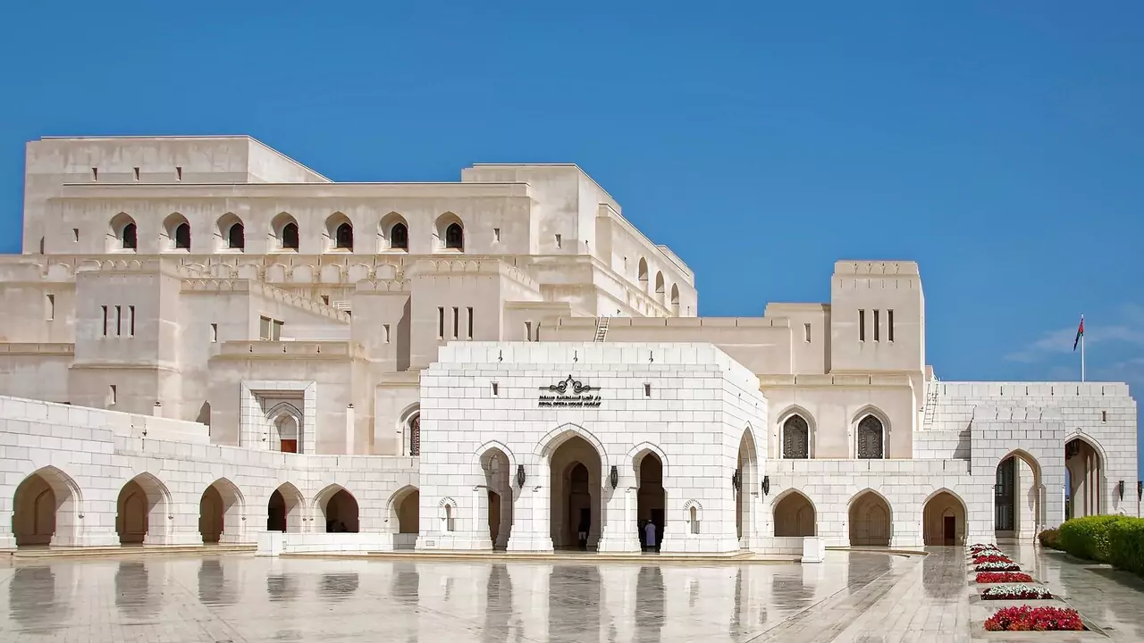 The grand Sultan's Palace in Muscat, featuring intricate architecture and lush gardens.