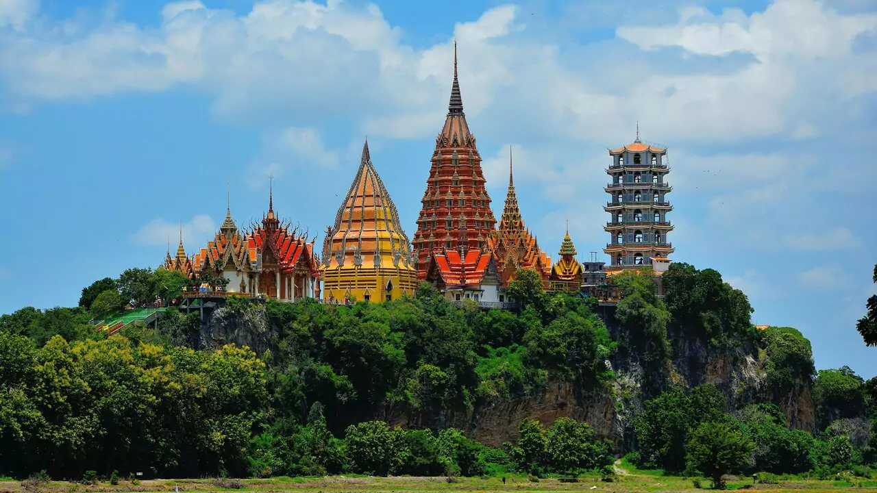 A hill crowned with golden pagodas glimmers in the sunlight.