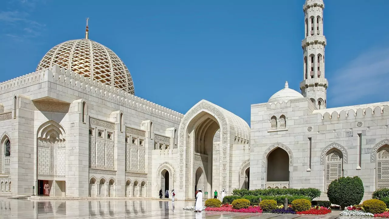 The Grand Mosque of Oman, highlighting its beautiful design and large courtyard.
