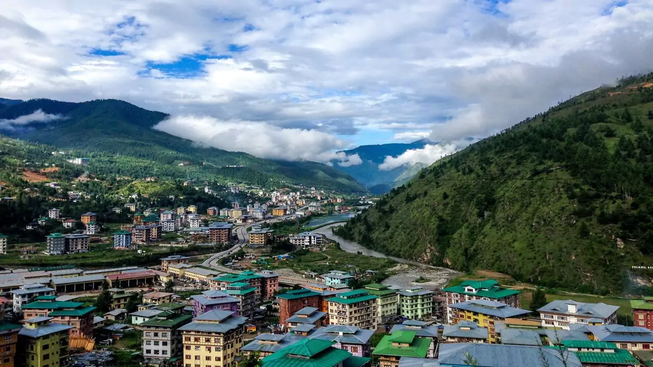 Aerial view in Nepal, showcasing a small town, vast landscapes and distant peaks.