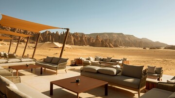 Cozy lounge area at a desert resort, featuring comfortable seating and stunning views of the desert.