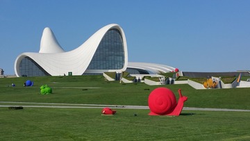 Heydar Aliyev Centre with a large snail sculpture displayed prominently outside.
