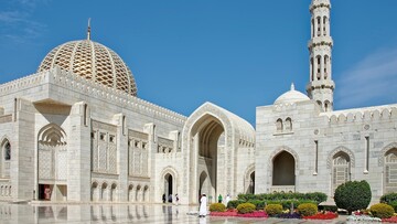 The Grand Mosque of Oman, highlighting its beautiful design and large courtyard.